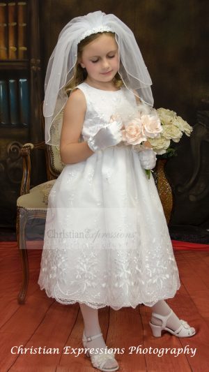 Embroidered organza first communion dress with ribbon and bow accents